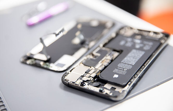 RUSSIA - July 27, 2020: Repair iPhone apple broken phone screen and replace used rechargeable batteries for recycling.