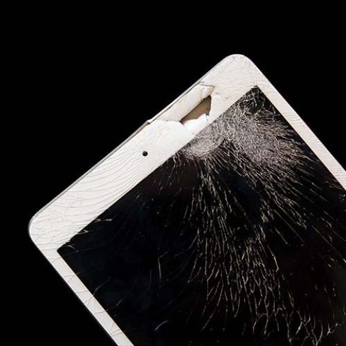 Tablet computer with broken screen on Isolated black background